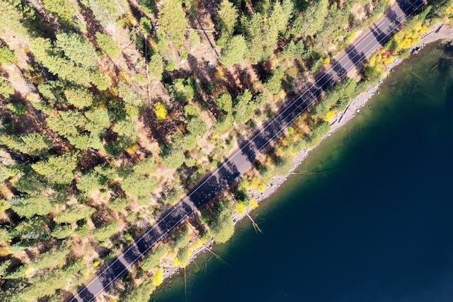 the aerial view of a lakeside road in Idaho